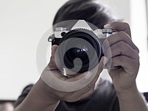 Men photograp holding vintage lens and camera