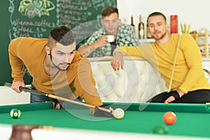 Men play billiard