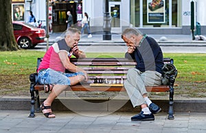 Men play chess.