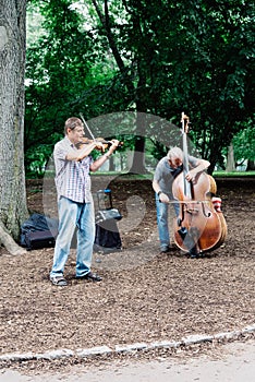 Men playing cello and violin in Central Park in New York