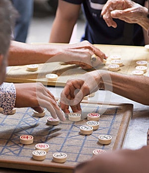 Men playing the checkers game on the streets of Phnom Penh in Cambodia