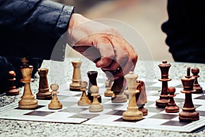 Men playing chess in the park