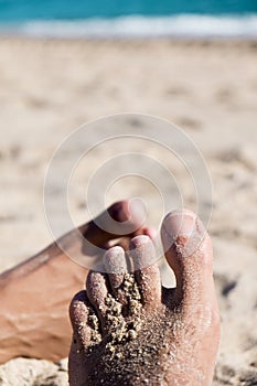 Men playing footsie on the beach