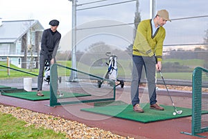 Men playing golf in golf course