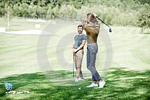 Men playing a golf outdoors