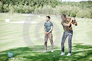 Men playing a golf outdoors