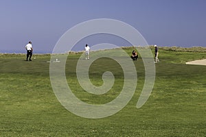 Men playing golf putting green