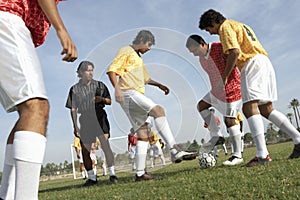 Men Playing Soccer While Referee Watching Them