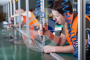 Men during precision work on production line photo