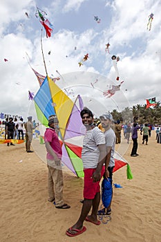 Men prepare to launch their kite on Negombo beach in Sri Lanka during the annual kite festival.