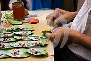 Men preparing betel chew, Myanmar