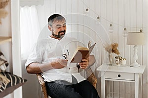 Men reading book in trailer, traveling in camper motor home