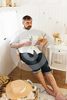 Men reading book in trailer, traveling in camper motor home