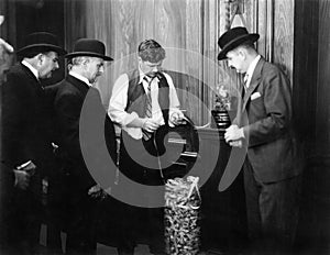 Men reading the ticker machine photo