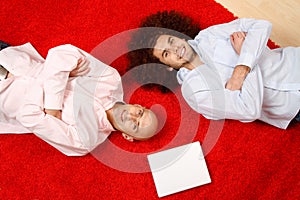 Men relaxing on rug