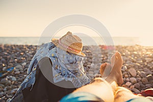 Men relaxing by sea in rocky beach