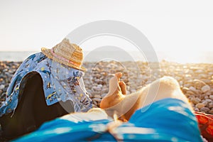 Men relaxing by sea in rocky beach