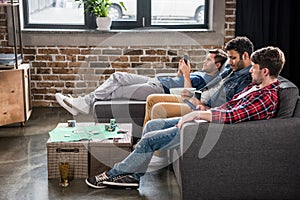 Men relaxing on sofa