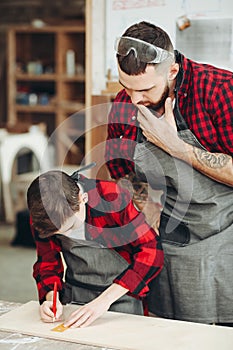 Men with ruler and pencil measuring wooden plank for work