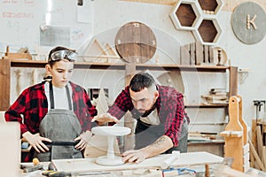 Men with ruler and pencil measuring wooden plank for work