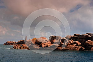 Men ruz lighthouse and pink granit coast boulder in Brittany