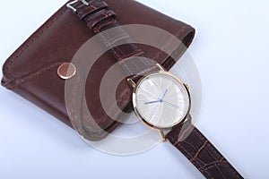 Men`s accessories for business and rekreation. Leather wallet, watch and smoking pipe on white background.. Top view