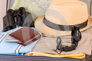 Men`s accessories and clothes in a suitcase for a long journey,