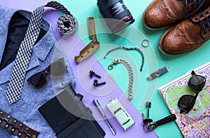 Men`s accessories, devices on lilac and turquoise background. travel and vacation, Top view, flat lay.