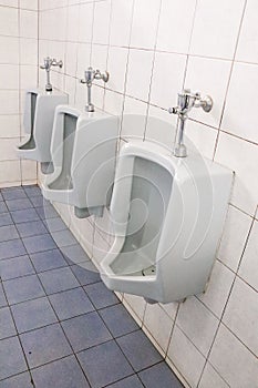 Men`s bathroom, design of white ceramic urinals for men