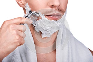 Men`s beauty. Handsome man shaving