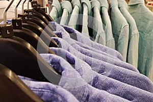 Men`s blue colored shirts on the vases at the retailer photo