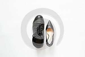 Men's boot and women's classic black shoes on a white background, different shoes, fashion