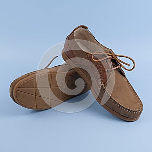 Men`s brown moccasins, loafers isolated on blue background