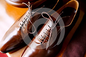 Men`s brown shoes made of genuine leather with laces close-up.