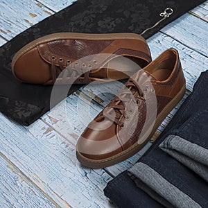 Men`s casual outfits for man clothing set with shoes, trousers, shirt on wooden background, Top view