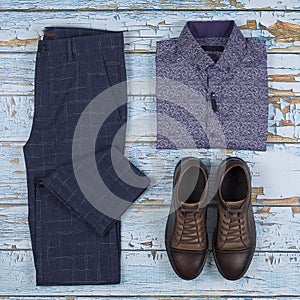 Men`s casual outfits for men clothing set with shoes, trousers, shirt on wooden background, Top view