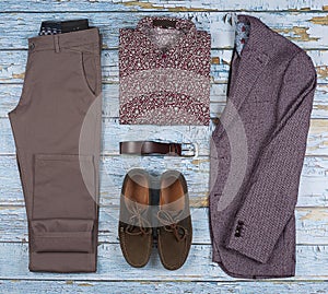 Men`s casual outfits for men clothing set with shoes, trousers, shirt on wooden background, Top view