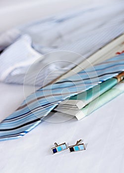 Men's classic shirts and newspaper on the bed