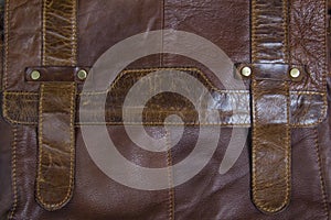 Men`s clothing worn wooden backgroundbrown leather men`s bag. men`s clothing worn wooden background