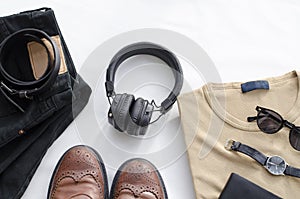 Men`s fashion, casual outfits with accessories. Flat lay, top view on white background, black jeans and t-shirt with boots.