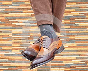 Men`s feet in pair of shoes and socks