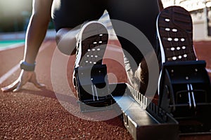 Men`s feet on starting block ready