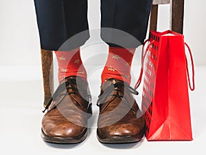 Men`s feet in stylish shoes and bright socks