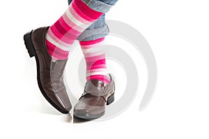 Men`s feet in stylish shoes and funny socks