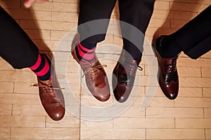 Men`s feet in stylish shoes and funny socks. male style