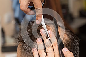 Men`s hair cutting scissors in a beauty salon