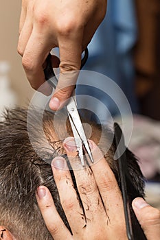 Men`s hair cutting scissors in a beauty salon