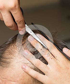 Men`s hair cutting scissors in a beauty salon