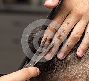 Men`s hair cutting scissors in a beauty salon