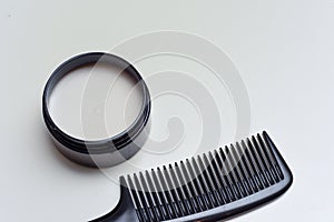 Men`s hair product paste with black comb isolated on white background
